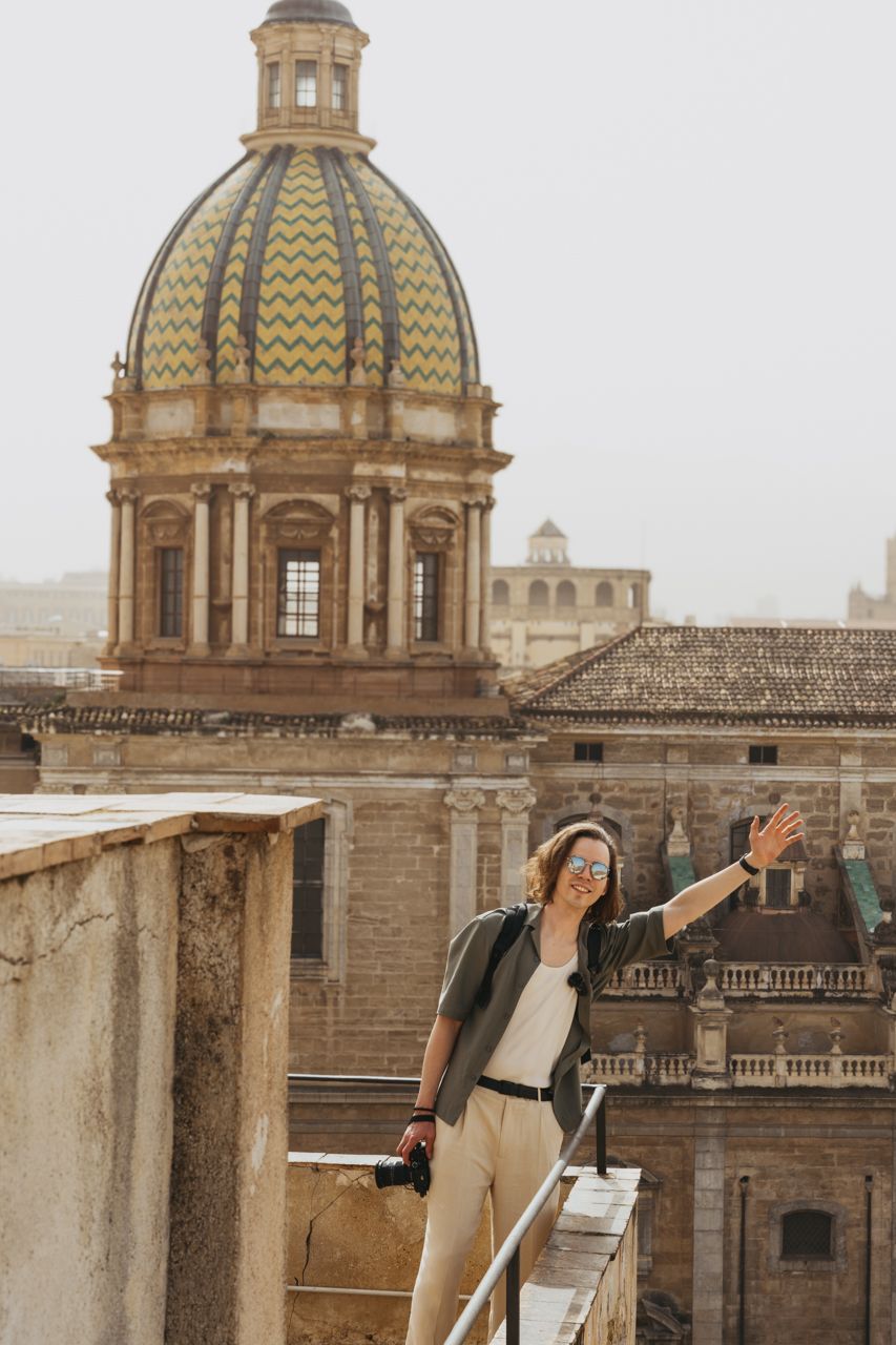 Man smiling and greeting at Santa Caterina Church roof