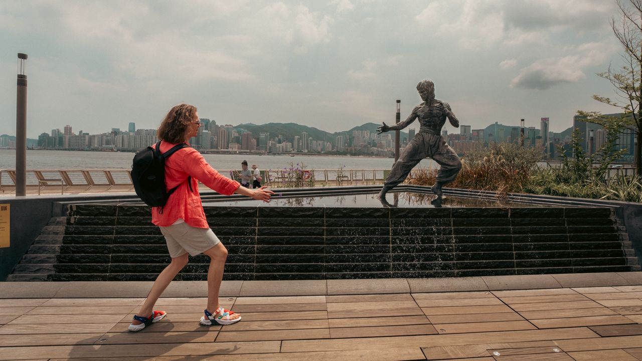 Man posing at Bruce Lee statue, Avenue of Stars