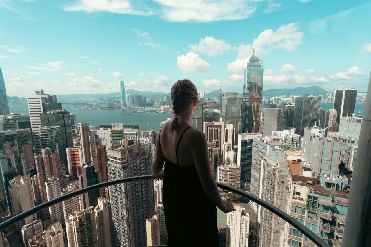 Woman with view of Hong Kong on a sunny day at Hopewell Center