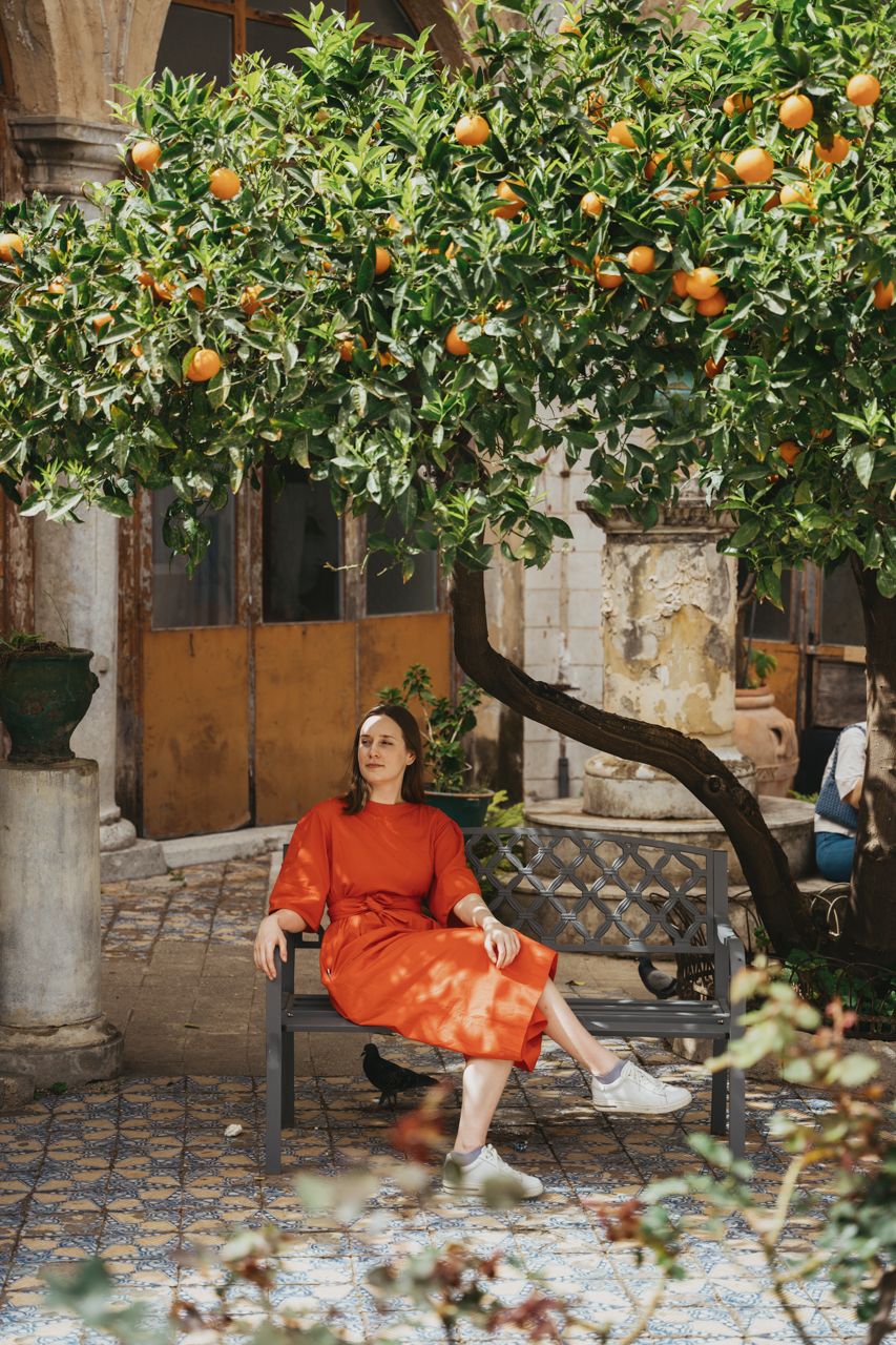 Women smiling under orange tree at Santa Caterina Monastery