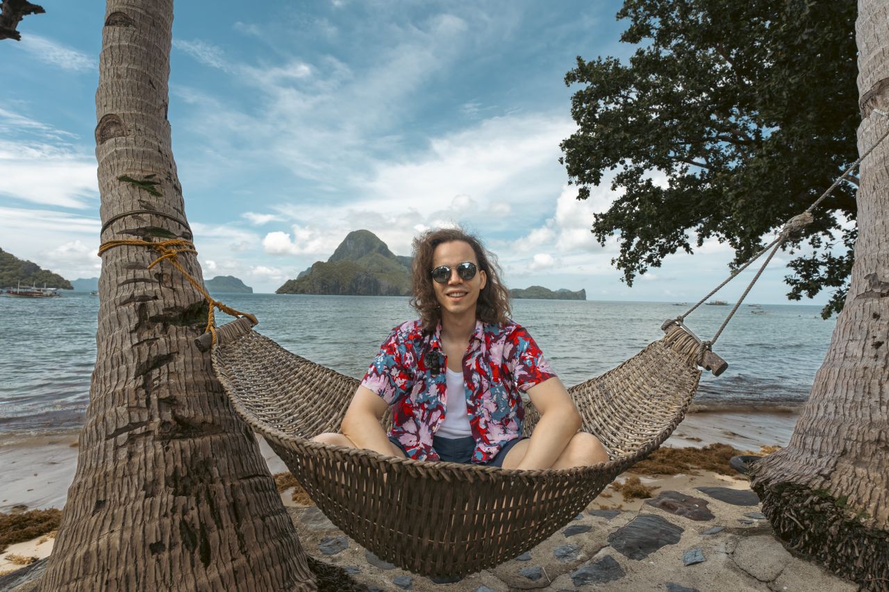 Man smiling in front of the sea in El Nido, Philippines