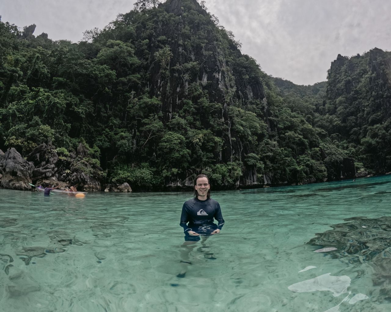 Man smiling standing in water at Barracuda Lake, Philippines