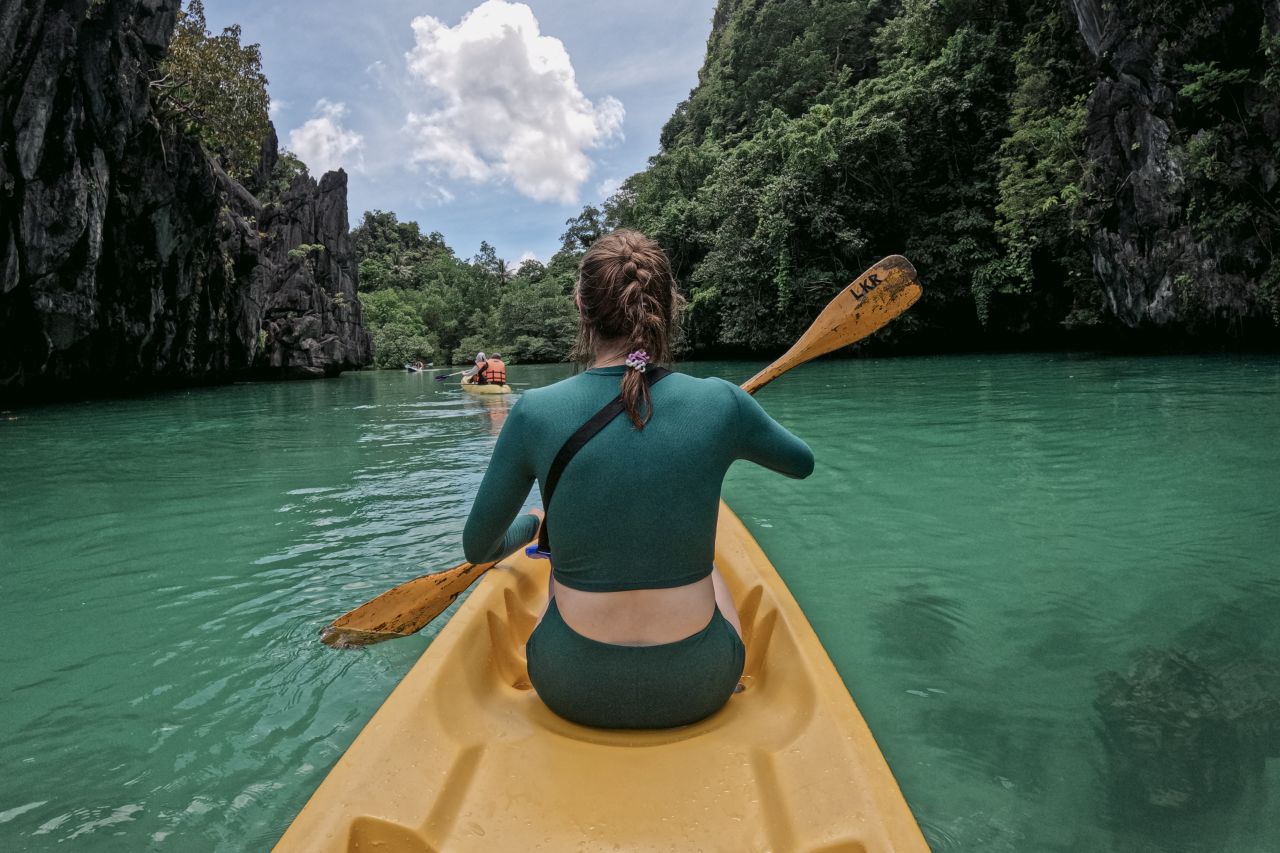 Woman kayaking at Big Lagoon, El Nido, Philippines