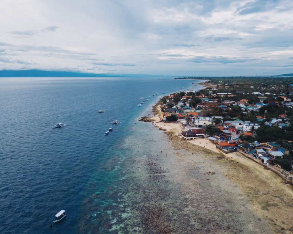 Aerial view of the beach line of Moalboal in Cebu on a sunny day.