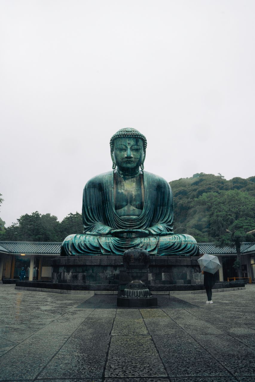 Full body front view of the sitting Buddha at Kotoku-in Temple, Kamakura, Japan.