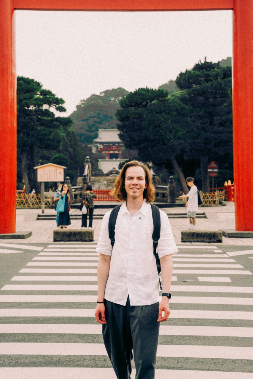 Man standing at the entrance to Tsurugaoka Hachimangu in Kamakura, Japan.