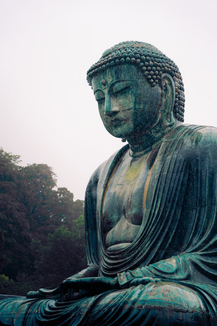 Portrait of the sitting Buddha at Kotoku-in Temple, Kamakura, Japan, on a rainy day.