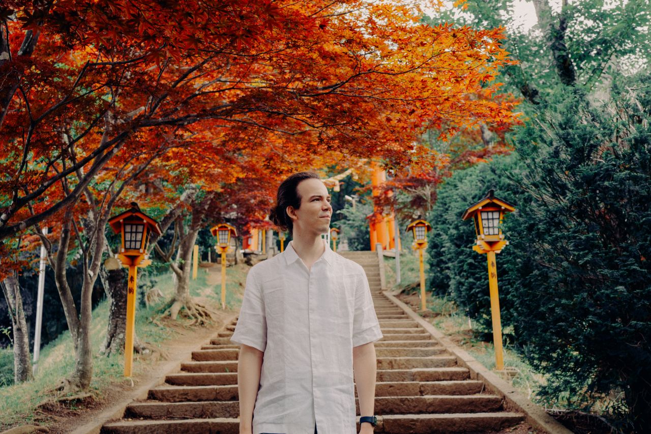 Portrait of a man on the stairs of Chureito Pagoda.