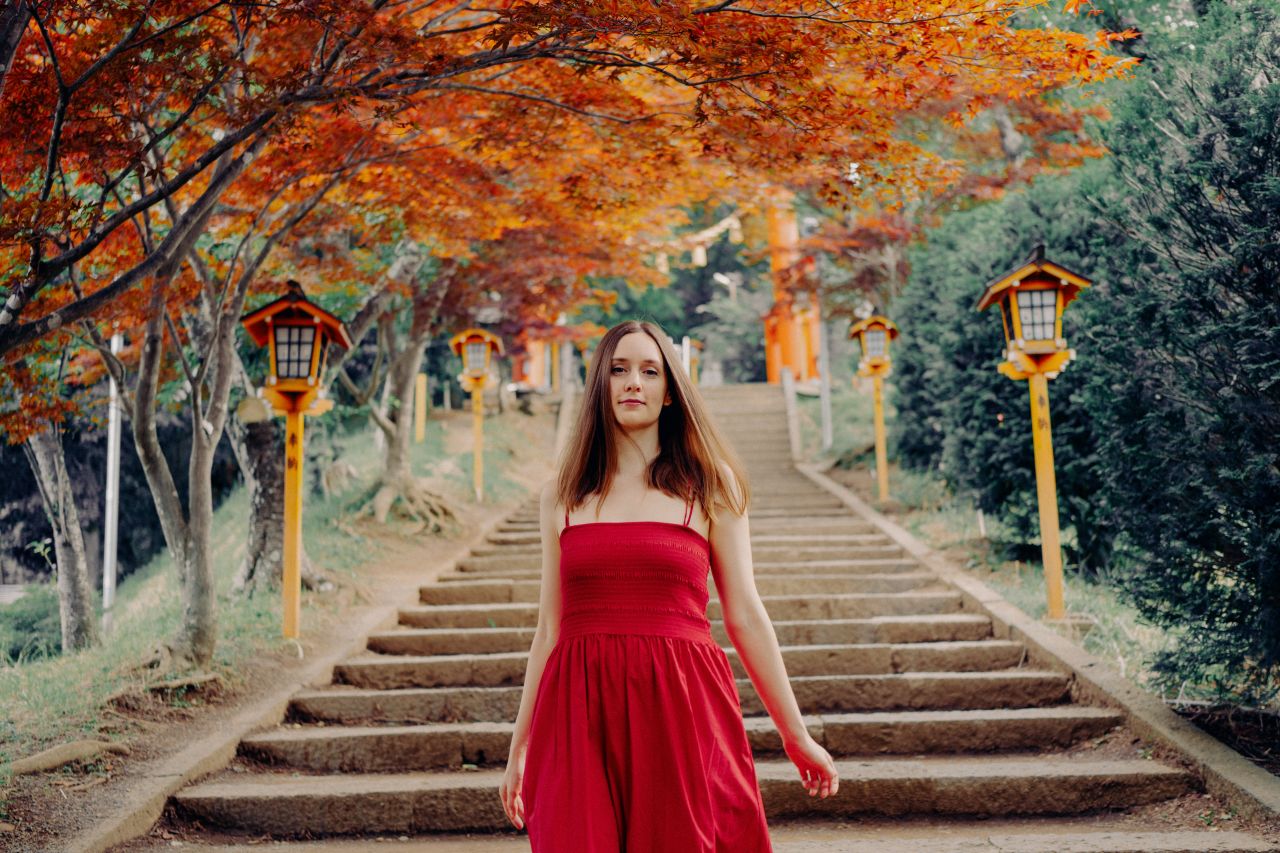 Portrait of a woman on the stairs of Chureito Pagoda.