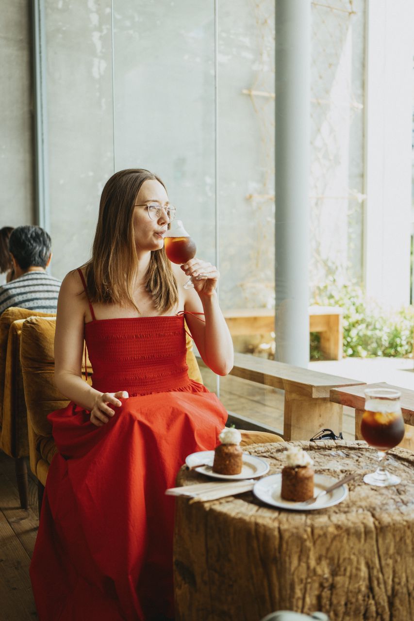 Woman enjoying iced coffee at Fab Cafe Fuji, Yamanashi.