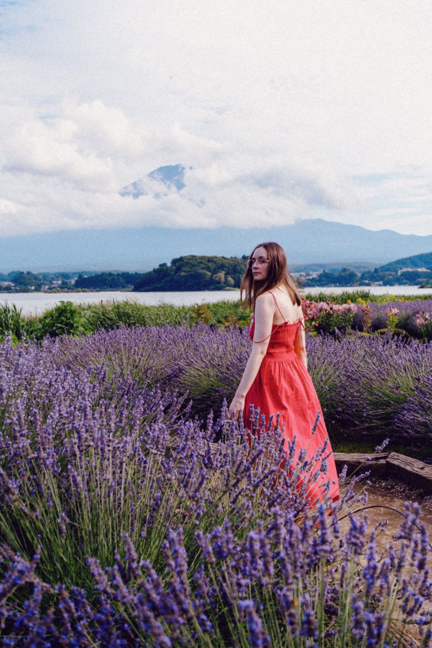 Woman in a red dress at lavender field with view of Mount Fuji at Oishi Park.