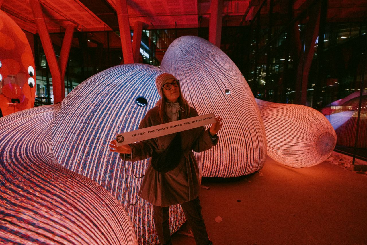 Another view of a woman at Amsterdam Light Festival installation.
